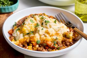 Plated shepherd’s pie garnished with parsley, served with a fork