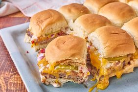 pale blue tray of bacon ranch burger sliders with melted cheddar cheese