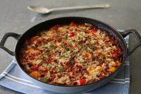2-handle braising pan with stuffed bell pepper casserole on blue towel