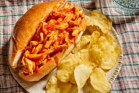 looking at a slow cooker buffalo chicken sandwich, with a side of potato chips