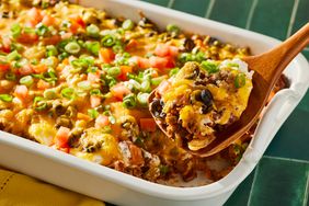 taco casserole with spoon holding one portion 