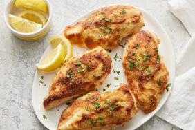 an overhead shot of parmesan crusted chicken on a white plate