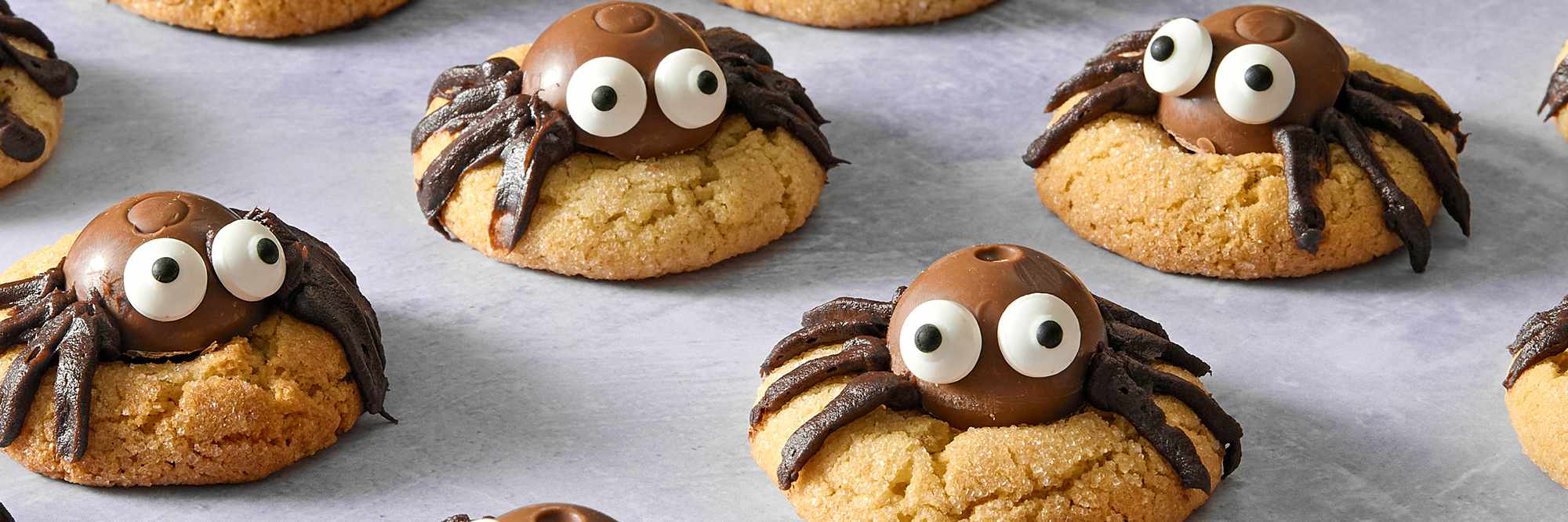 Peanut Butter Spider Cookies with candy eyes and frosting legs