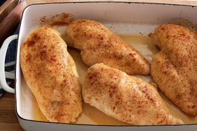 a high angle view of simple baked chicken in a white baking dish