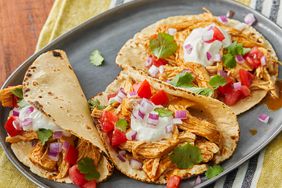 high angle, close up on a plate of three fiesta slow cooker shredded chicken tacos
