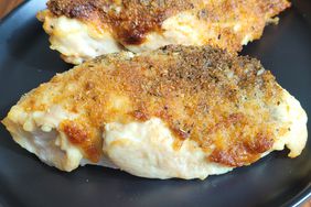 Browned chicken breast on black plate