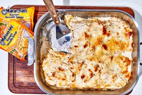 overhead view of ramen chicken Alfredo casserole with ramen packets and spatula
