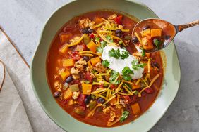 butternut squash chili topped with shredded cheese, sour cream and cilantro. 