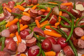 closeup of sheet pan dinner with red potatoes, green beans, carrots, and sausage slices