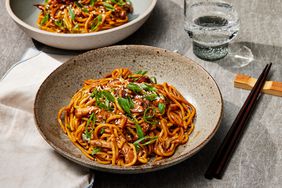 close up on two bowls of slow cooker honey garlic chicken noodles 