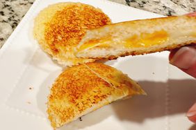 mini round crustless grilled cheese sandwiches on white plate