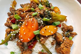 ground turkey stir fry on rice on white plate
