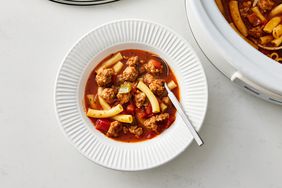 Slow Cooker Italian Sausage Soup in a bowl with a spoon and in a slow cooker 