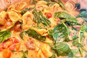 closeup of creamy tortellini soup with sausage, tomatoes and spinach