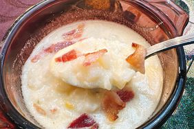overhead view of potato soup with bacon in clear brown soup bowl