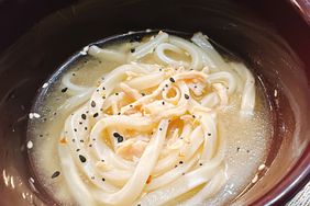 overhead closeup of plum colored bowl of noodle soup