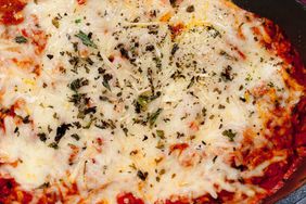 skillet with tortellini pasta in tomato sauce, covered with melted mozzarella cheese