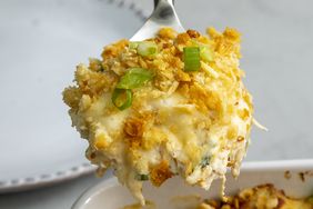 looking at a heaping spoonful of chicken casserole being lifted out of the casserole dish