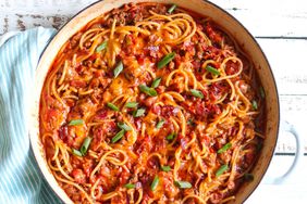 cowboy spaghetti in tomato sauce topped with scallions