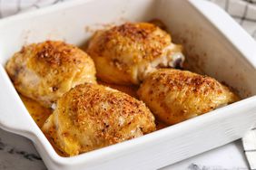 Baked chicken thighs in white casserole dish