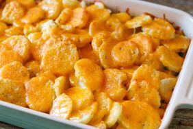rectangular casserole with sliced potato and cheese on top