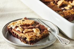  S'more brownie piece on plate with fork and baking dish.