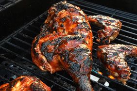 closeup of pieces of Chef John's Barbecue Chicken on a grill grate