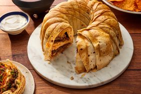 a high angle view of a crunchwrap ring made in a bundt pan and filled with layers of seasoned beef, nacho cheese, and crunchy chips, all wrapped in tortillas