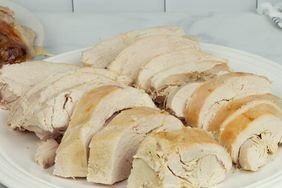 close up view of sliced Turkey on a white platter 