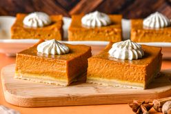 pumpkin chai latte bars arrayed on board and a tray topped with whipped cream