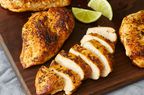 looking down at a few spicy garlic lime chicken breasts with one fully sliced