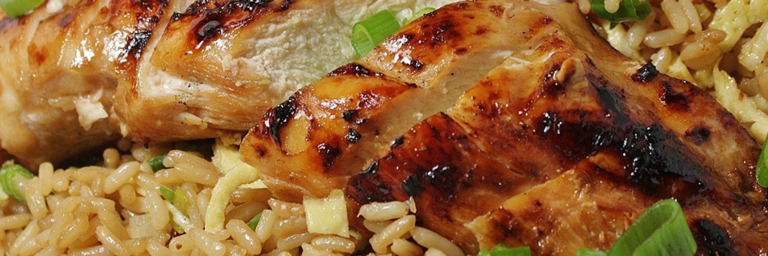 a sliced chicken breast on a bed of rice