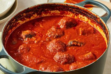 A pot of Italian Sunday sauce with meatballs and sausage