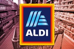 Aldi logo over a photo of an Aldi store aisle with a purple and red halftone overlay
