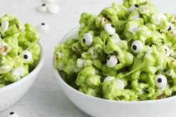 two bowls of green popcorn with edible eyes